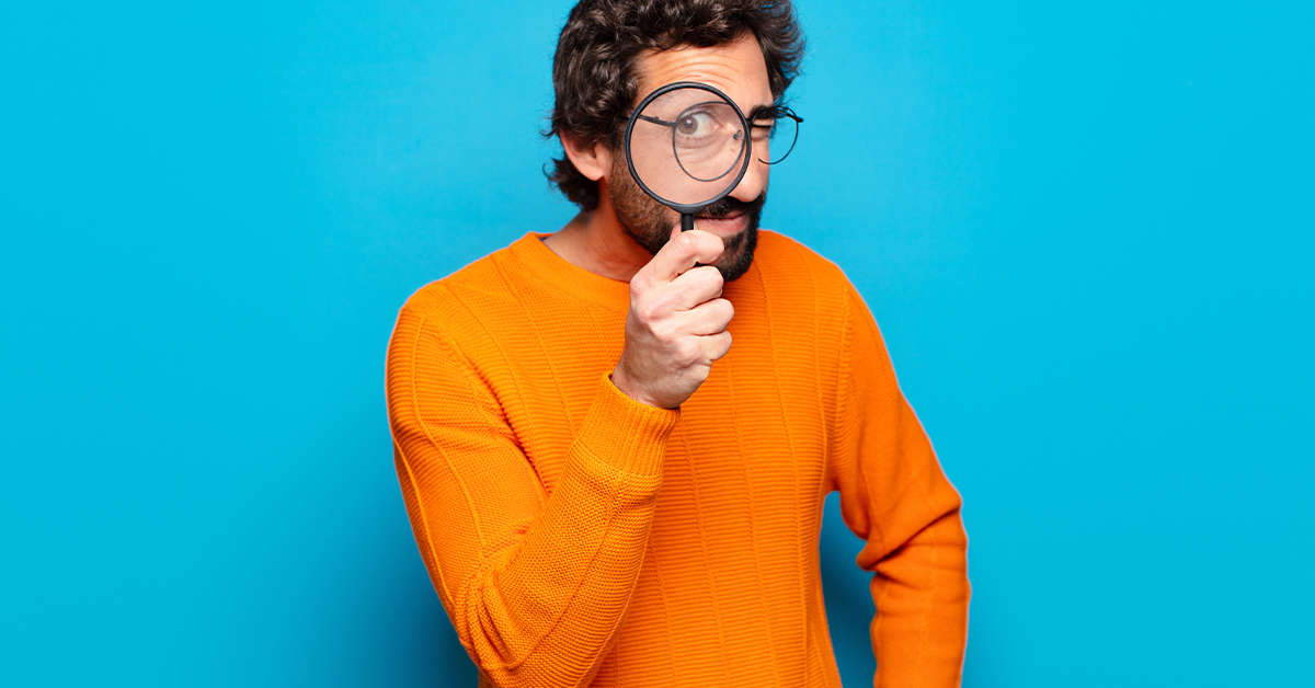 Man using magnifying glass 409024874