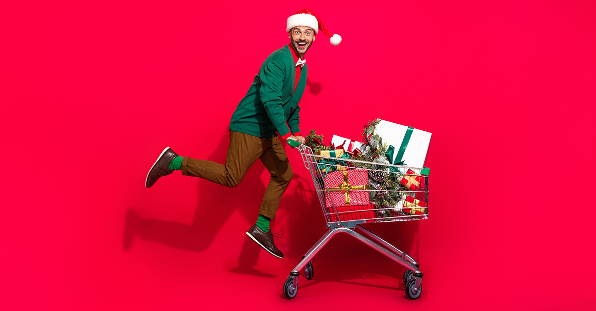 Happy man pushing shopping cart