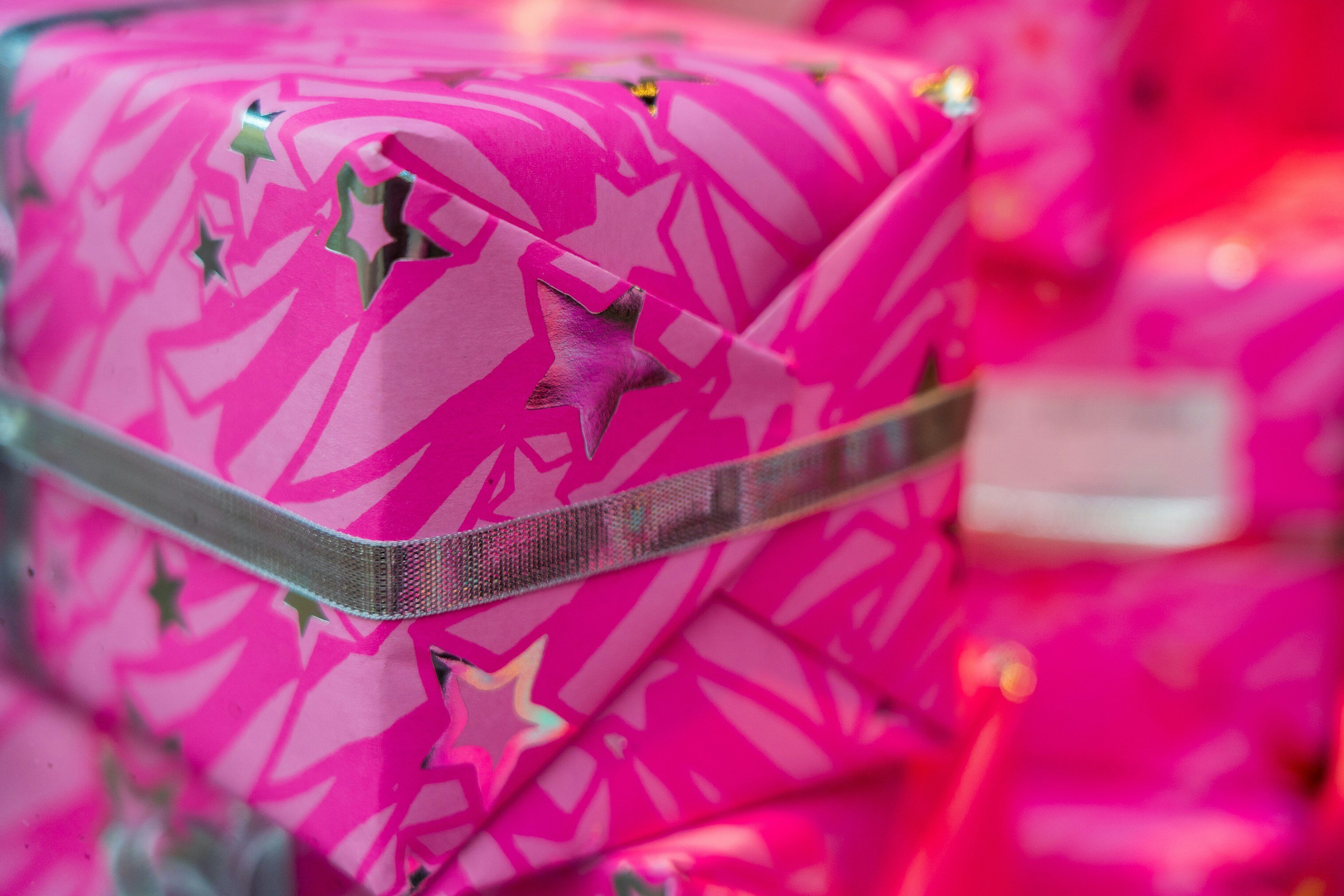 A gift wrapped in pink paper with stars on it