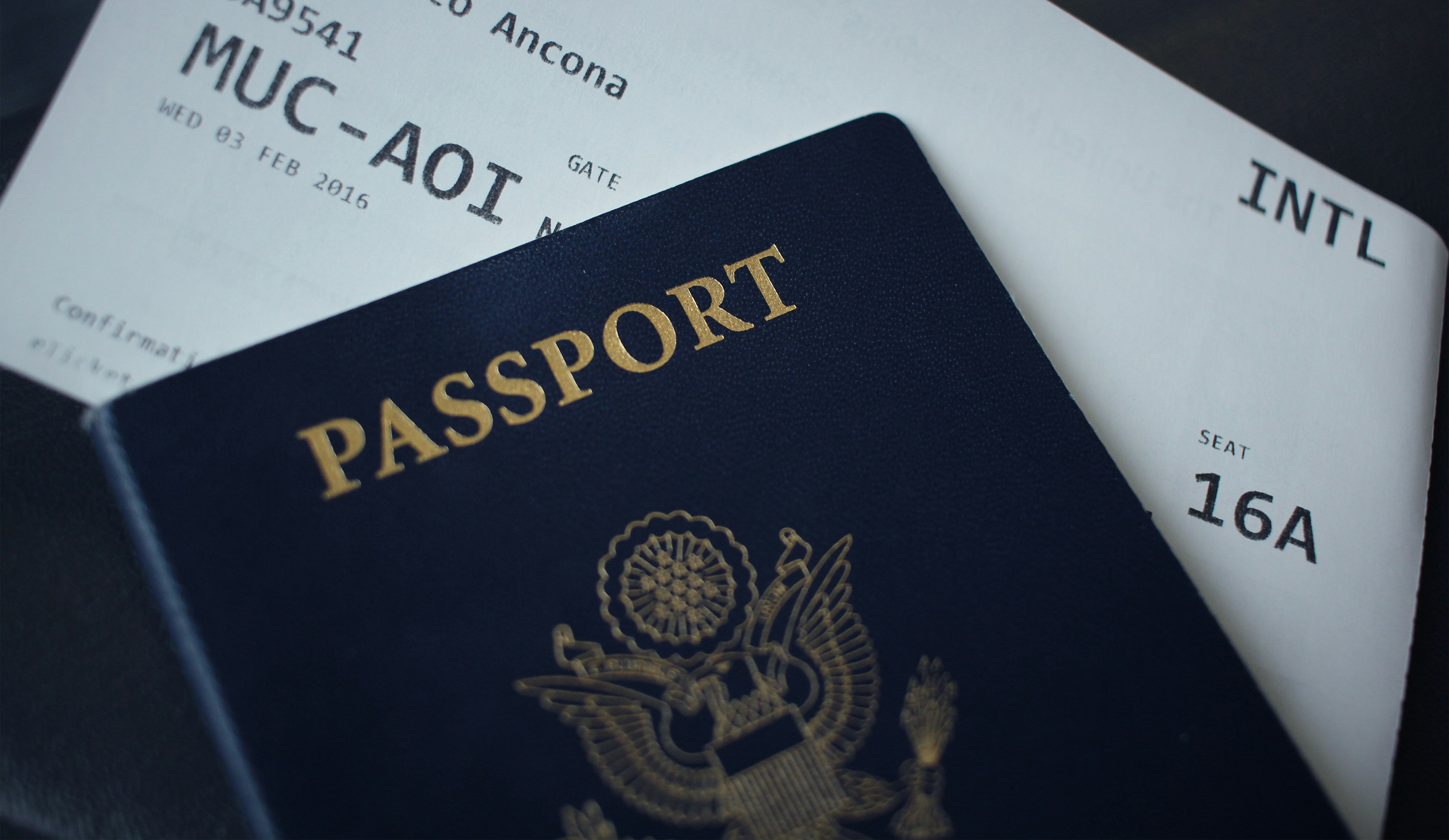 A passport sitting on top of a plane ticket